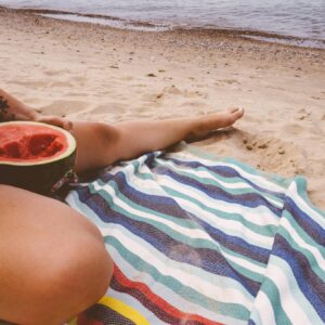 Person Eating Watermelon by the Beach