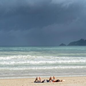 Two Persons Doing Sunbathing