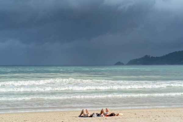 Two Persons Doing Sunbathing