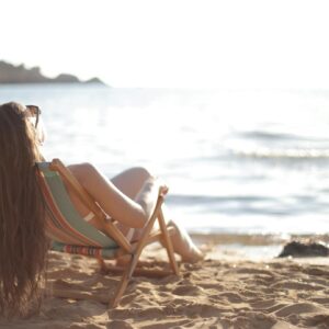 Woman in White Bikini Reclining in Beach Chair