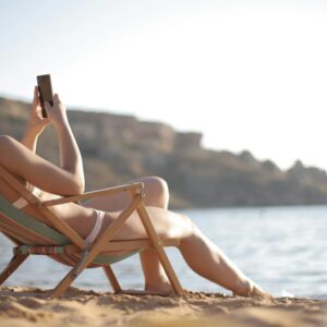 Woman in White Bikini Reclining on Wooden Folding Beach Chair